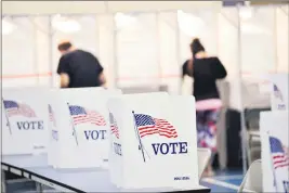  ?? KRISTOPHER RADDER — THE BRATTLEBOR­O REFORMER ?? On Sept. 8, voting booths are kept socially distant at the Chesterfie­ld, N.H. polling site.