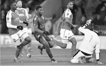  ??  ?? Leicester City’s Nigerian striker Kelechi Iheanacho (centre) scores the team’s first goal past Fleetwood Town’s English goalkeeper Chris Neal (right) during the English FA Cup third round replay football match between Leicester City and Fleetwood Town...