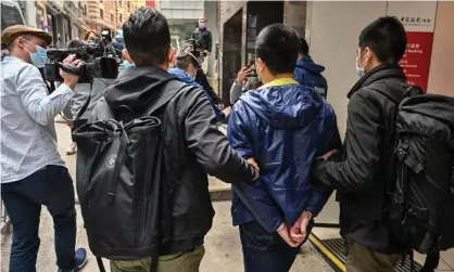  ?? Photograph: Peter Parks/AFP/Getty Images ?? Police lead away one of the 55 activists arrested on Wednesday. The US, UK, Australia and Canada have jointly expressed serious concerns about the crackdown.