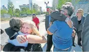  ?? [AP PHOTO] ?? Susan Adieh, left, cousin, and other family members of Noor Salman receive hugs from friends Friday after a jury found Salman not guilty on all charges at the Orlando Federal Courthouse in Orlando, Fla. The widow of the gunman who slaughtere­d 49 people...