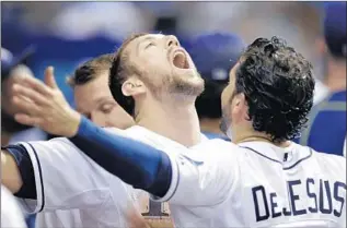  ?? Chris O’Meara Associated Press ?? TAMPA BAY’S Steven Souza Jr. and David DeJesus celebrate after Souza scored in the eighth.