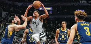  ?? Chuck Burton / Associated Press ?? Devin Vassell, driving to the hoop in a recent loss to the Indiana Pacers at the AT&T Center, and the Spurs begin a three-game road trip Sunday night against the Golden State Warriors.