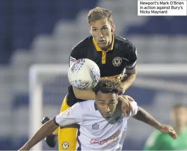  ??  ?? Newport’s Mark O’Brien in action against Bury’s Nicky Maynard