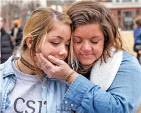  ??  ?? Meggie Meyer, right, holds her daughter, Ellie, during Saturday’s rally against gun violence.