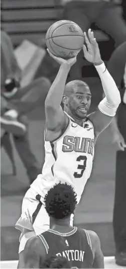  ?? ELSA/GETTY IMAGES ?? Chris Paul (3) of the Suns takes a shot as Elfrid Payton of the Knicks defends in the third quarter on Monday in New York City.