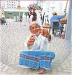  ??  ?? An elderly man is making ‘gargour’, a traditiona­l fishing tool in the Arabian Gulf region.