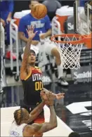  ?? AP photo ?? Jordan Clarkson of the Jazz puts up a shot against the 76ers’ Dwight Howard during the second half of Utah’s 134-123 victory over Philadelph­ia on Monday.