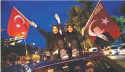  ??  ?? People wave flags in Istanbul during the elections on Sunday.