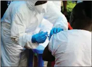  ?? AP/AL-HADJI KUDRA MALIRO ?? A health care worker from the World Health Organizati­on gives a front-line aid worker an Ebola vaccinatio­n Wednesday in Mangina, Democratic Republic of Congo.