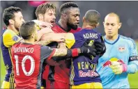  ??  ?? Toronto FC forward Jozy Altidore (17) scuffles with New York Red Bulls midfielder Tyler Adams (4) after teammate Sebastian Giovinco (10) was pushed to the ground during first half MLS action in Toronto on Sunday.
