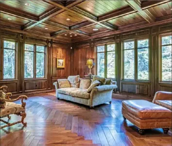  ??  ?? The study is paneled and has a coffered wood ceiling.