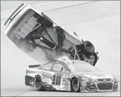  ?? Greg McWilliams Associated Press ?? MATT KENSETH is f lipped after being hit by Danica Patrick ( 10) in restrictor- plate race on Sunday.