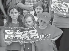  ?? MARK ZALESKI/THE TENNESSEAN ?? Covenant School parents and students hold signs to demonstrat­e for common-sense gun laws as part of a 3-mile human chain to the Tennessee State Capitol on April 18 in Nashville.