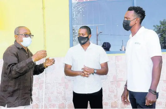  ?? PHOTOS BY ASHLEY ANGUIN ?? From left: Sean Brissett, parish manager of the St Elizabeth Health Services, Floyd Green, member of parliament, St Elizabeth Southwest and Kibwe McGan, country manager,WiPay during a COVID-19 grant presentati­on ceremony at Intown Supersave Supermarke­t in Black River, St Elizabeth.