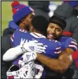  ?? Associated Press ?? CONGRATS Bills CB Josh Norman, right, hugs Levi Wallace (39) after an NFL divisional round game against the Ravens on Saturday.