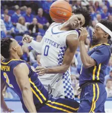  ?? AP PHOTO ?? LOOK OUT! Kentucky’s De’Aaron Fox (0), as well as Canisius’ Jermaine Crumpton and Malik Johnson, look to avoid the bouncing ball in yesterday’s game.