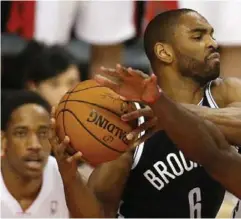  ??  ?? Raptors’ Patrick Patterson takes an elbow to the jaw from Brooklyn’s Alan Ander