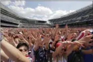  ?? ASSOCIATED PRESS FILE ?? Fans cheer for the United States against Belgium during a Brazil 2014 World Cup viewing party at Soldier Field in Chicago.