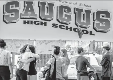  ?? Photograph­s by Brian van der Brug Los Angeles Times ?? CLASSMATES MINGLE as they retrieve their belongings Tuesday from Saugus High School, where a gunman killed two last week.