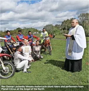  ?? ?? Rev George Lackenby blesses motorcycle stunt riders and performers from Planet Circus at the Angel of the North