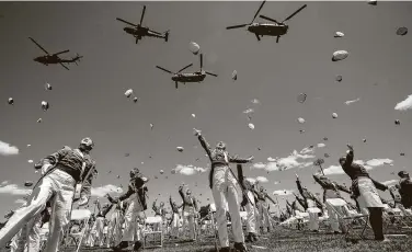  ?? John Minchillo / Associated Press ?? U.S. Military Academy graduating cadets celebrate by throwing their caps in the air at the end of their commenceme­nt ceremonies on Saturday at West Point, N.Y.