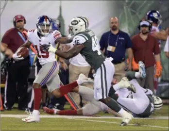  ?? BILL KOSTROUN — THE ASSOCIATED PRESS ?? Giants wide receiver Hunter Sharp (15) stiff-arms Jets linebacker Neville Hewitt (46) on his way to a touchdown during the first quarter of Friday’s preseason game in East Rutherford.