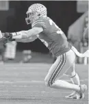  ?? BARBARA J. PERENIC/THE COLUMBUS DISPATCH ?? Buckeyes linebacker Tommy Eichenberg tries to make a play against Purdue.