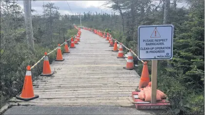  ?? PHOTOS BY ASHLEY FITZPATRIC­K/THE TELEGRAM ?? The Power’s Pond walking trail was closed for more than a month during the summer of 2018. After an initial clean-up effort, absorbent pads and booms — visible in these file photos — remained along the boardwalk and were monitored daily, to continuing capture the oil contaminat­ing the marsh running between the city’s industrial area and the popular local pond. Oil-stained boardwalk planks have been identified for replacemen­t later this year.