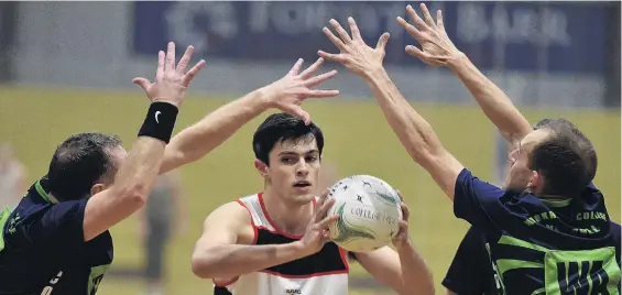  ?? PHOTO: GREGOR RICHARDSON ?? Double team . . . Southern Huskies’ Kyle Owen looks to pass the ball as College duo Mark Dore (left) and Sam Thomson defend him during their Premier Men’s netball match at the Edgar Centre on Monday night.