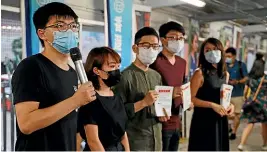  ?? AP ?? Pro-democracy activist Joshua Wong, left, speaks to the media about Beijing’s national security legislatio­n proposal for Hong Kong. Inset, Chris Patten.