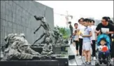  ?? CUI XIAO / FOR CHINA DAILY ?? Visitors pay respect to the victims at the Memorial Hall for the Victims of the Nanjing Massacre by Japanese Invaders in Nanjing, Jiangsu province, in July.