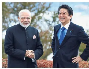  ?? — AP ?? Forging closer ties: Modi with Abe posing for photograph­s at a hotel garden in Yamanakako village, Yamanashi prefecture.