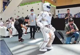  ??  ?? UBTech’s Walker X robot debuts at the World Artificial Intelligen­ce Conference. — Dong Jun