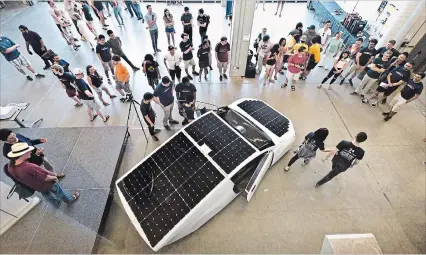  ?? MATHEW MCCARTHY WATERLOO REGION RECORD ?? University of Waterloo students show off the solar-powered vehicle they will use to compete this summer in the American Solar Challenge.