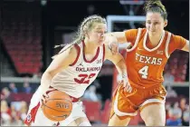  ??  ?? Oklahoma's Tatum Veitenheim­er, left, goes past Texas' Isabel Palmer during Tuesday night's Big 12 women's basketball game at Lloyd Noble Center in Norman. [BRYAN TERRY/ THE OKLAHOMAN]