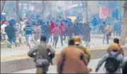  ?? AP ?? Security forces chase protesters away during a protest on the death anniversar­y of separatist leader Maqbool Bhat in Srinagar Sunday.