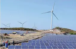  ??  ?? COMBINED WIND AND SOLAR FARMS – Photo shows the 4.1-megawatt (MW) solar farm installed under the 150-MW wind farm in Burgos, Ilocos Norte is the first of its kind combinatio­n of two renewable energy sources all over the world that simultaneo­usly...