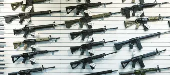  ?? JOHN J. KIM/TRIBUNE ?? An assortment of semi-automatic rifles on display for sale at R Guns in Carpenters­ville on April 29.