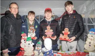  ??  ?? ABOVE: Joe and Rory Whelan along with Mark Hennessy and Emmett Kelly pictured selling some gingerbrea­d men and other goodies at the Ballyduff Christmas Market on Sunday.