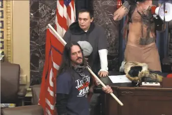  ?? U.S. Capitol Police ?? An image from U.S. Capitol Police video shows Paul Allard Hodgkins, 38, of Tampa, Fla., holding a flag in the Senate chamber after breaching the U.S. Capitol on Jan. 6 in Washington.