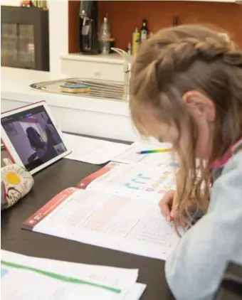  ??  ?? Een meisje (l.) werkt ijverig aan haar huiswerk, thuis in Gent. In Franstalig België blijven de scholen niet alleen gesloten (r.), ze bieden ook geen nieuwe leerstof aan.