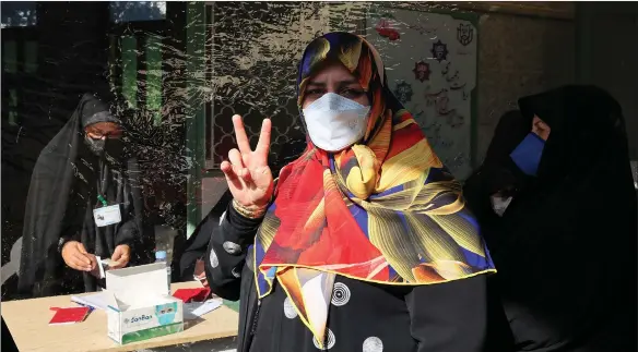  ??  ?? An Iranian woman at the polling station in the presidenti­al election in Tehran, but the turnout is estimated at 42 per cent, which would be the lowest since the country’s 1979 Islamic Revolution