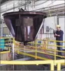  ??  ?? ARMANDO GODINA empties a bucket into a sorting tray at a federal f ish collection facility near Tracy, Calif.