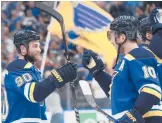  ?? MICHAEL THOMAS/AP ?? Blues’ Ryan O’reilly (90) and Brayden Schenn celebrate after a win over the Wild in Game 6 of a first-round playoff series Thursday in St. Louis.