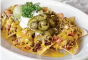  ??  ?? Diners can’t go wrong with the Tex-Mex staple of beef fajita nachos at Rita’s Cantina.