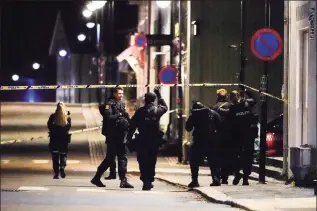  ?? Hakon Mosvold Larsen / Associated Press ?? Police stand at the scene after an attack in Kongsberg, Norway, on Wednesday. Several people have been killed and others injured by a man armed with a bow and arrow in a town west of the Norwegian capital, Oslo.