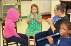  ?? MICHILEA PATTERSON — DIGITAL FIRST MEDIA ?? Children learn how to hold and play the recorder during a free music program at Christ Episcopal Church in Pottstown on Tuesday.