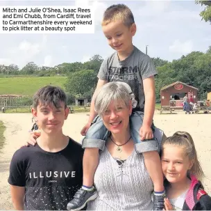  ??  ?? Mitch and Julie O’Shea, Isaac Rees and Emi Chubb, from Cardiff, travel to Carmarthen­shire every weekend to pick litter at a beauty spot