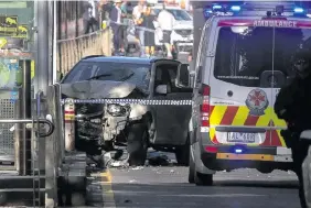  ?? Photo: Reuters ?? Australian police stand near a crashed vehicle after they arrested the driver of a vehicle that had rammed into pedestrian­s at a crowded intersecti­on near the Flinders Street train station in central Melbourne, Australia, December 21, 2017.