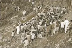  ?? PTI ?? Rescue workers look for survivors after a bus carrying students fell into a gorge near Nurpur in Kangra district of Himachal Pradesh on Monday evening